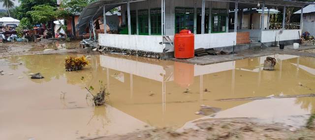 Salah satu bangunan di Desa Togid masih dikelilingi genangan air pasca banjir bandang yang melanda wilayah tersebut.