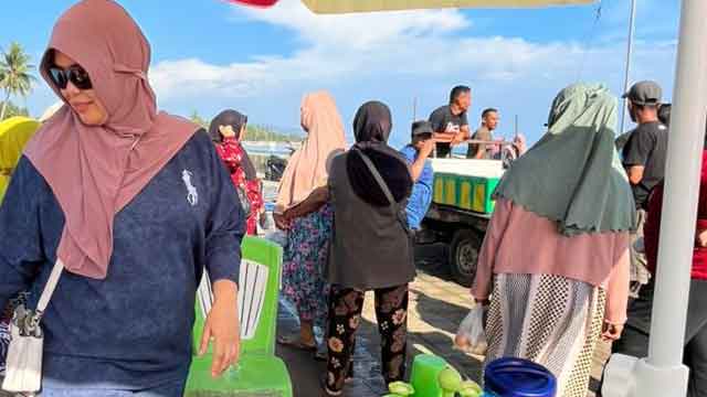 Ketua Fraksi PDI Perjuangan DPRD Bolmut, Dewi Zandra Astuti Mondo, berinteraksi dengan warga pengolah ikan teri di pesisir Desa Buko, Kecamatan Pinogaluman, saat peringatan Hari Kartini, Senin (21/4/2026)